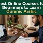 Beginner studying Quranic Arabic online with a laptop, notebook, and Quran on a wooden rehal.